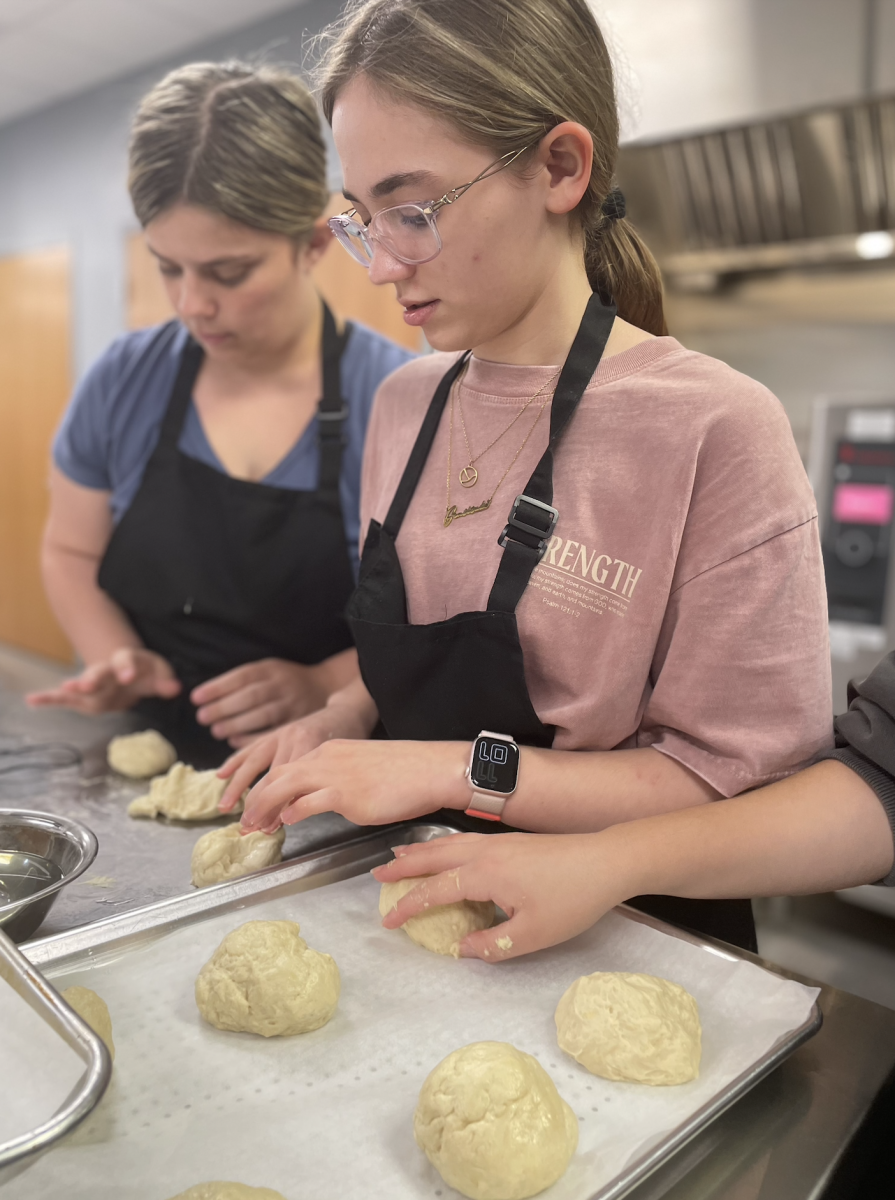 Senior Brianna McFarland works on making her yeast rolls during culinary class. During class, students had to finish the process of baking their rolls. ‘’We made yeast rolls during class," McFarland said. "This was a two day process because you have to let the dough rise. Last period we made the dough and this period we baked them. It’s a tedious process, but fun process."